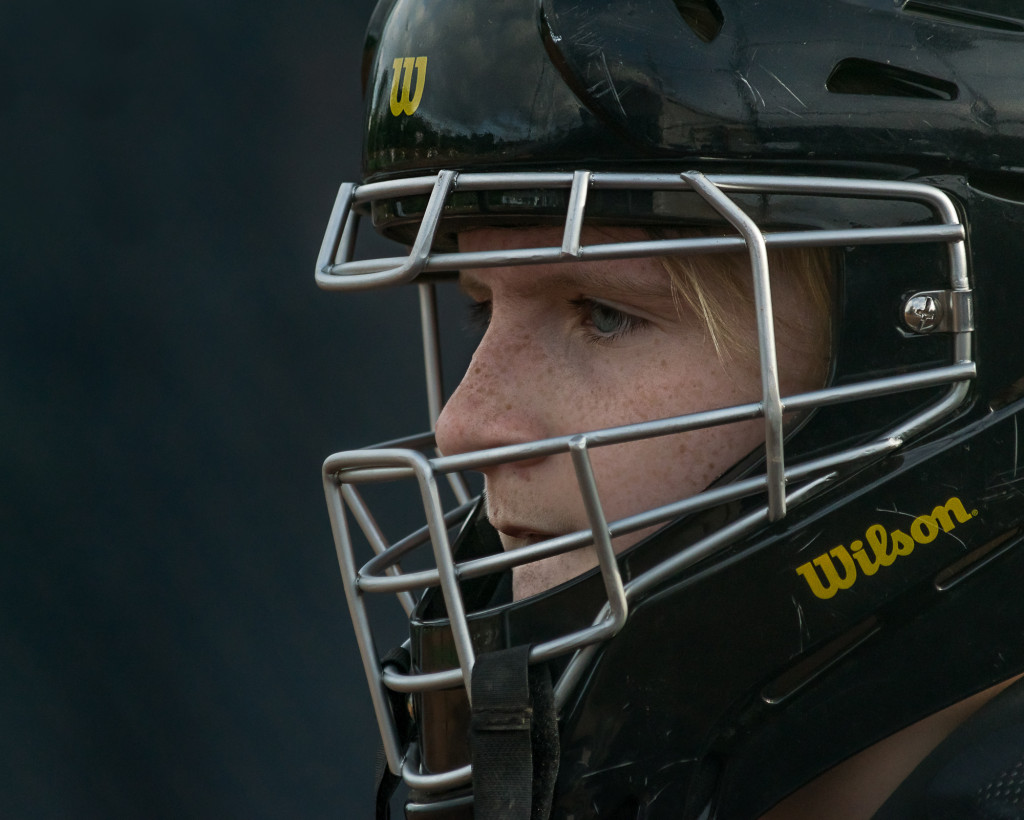 A Softball Catcher focusing during a game.