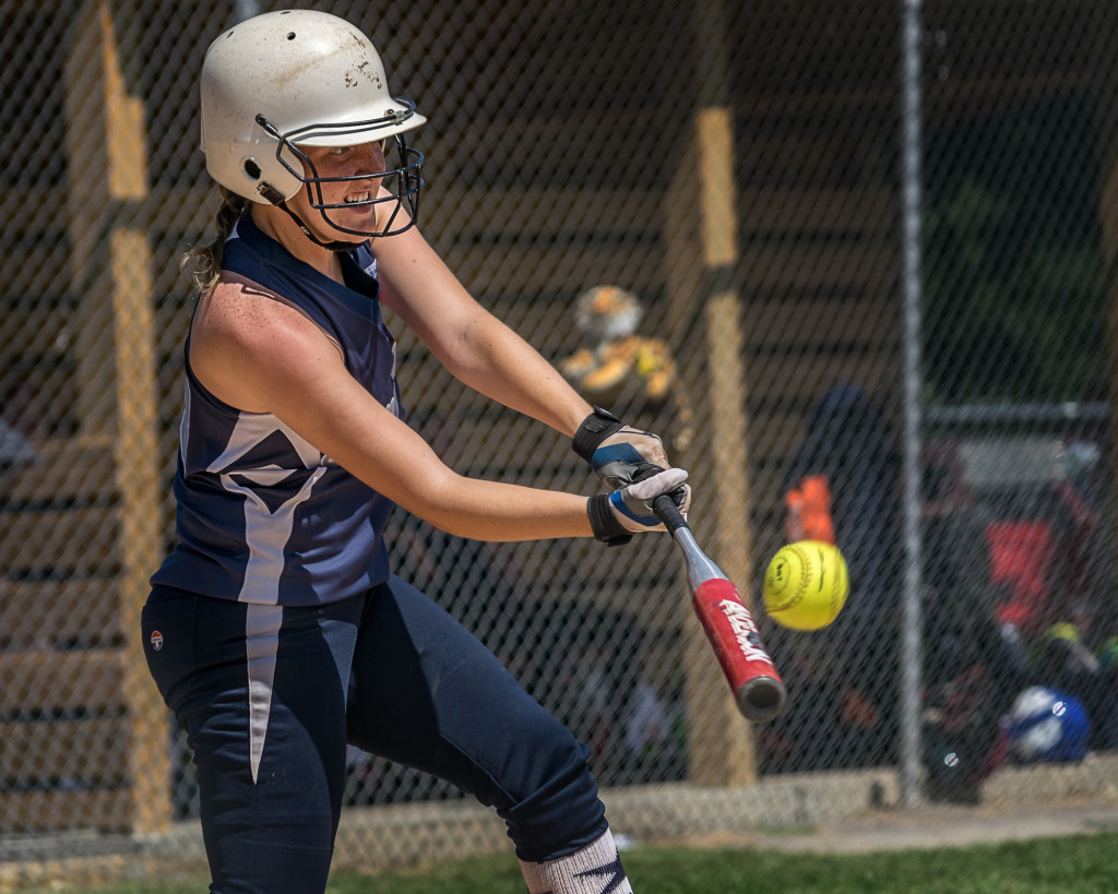 A Softball Player makes contact during a state tournament game