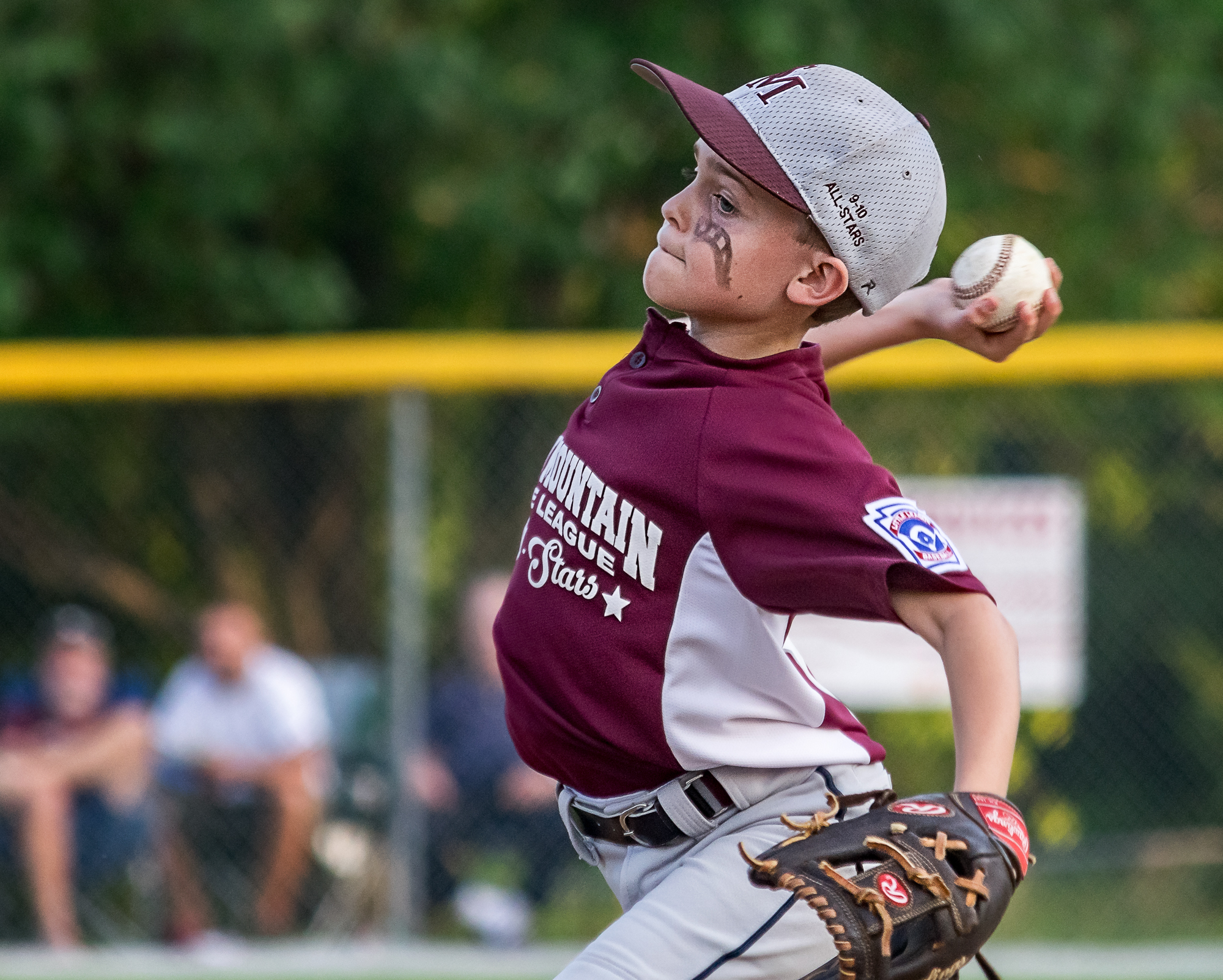 A Little League pitcher delivers during a game