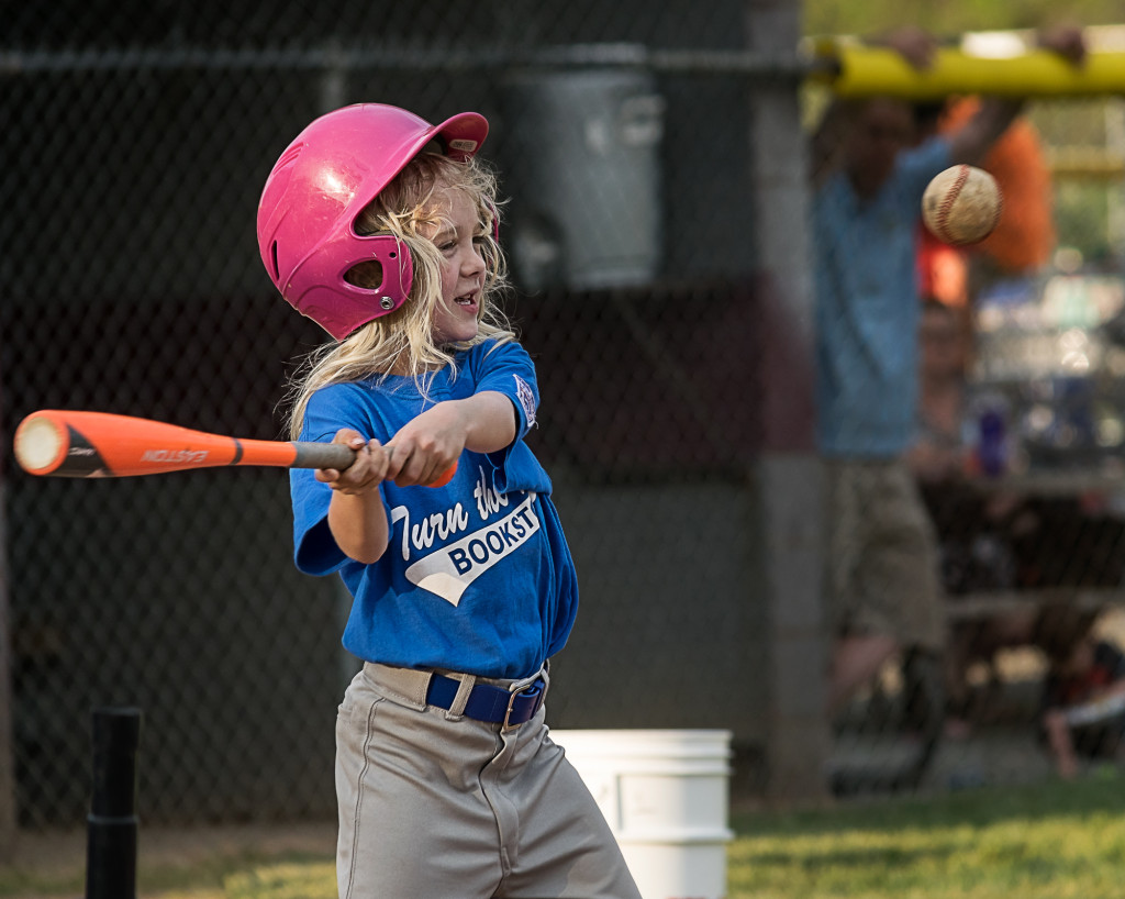 A T-Ball batter swings for the ball during a game.